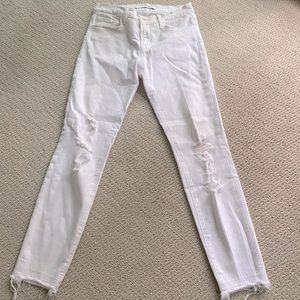 J Brand high rise white skinny jeans with frayed hem at bottom